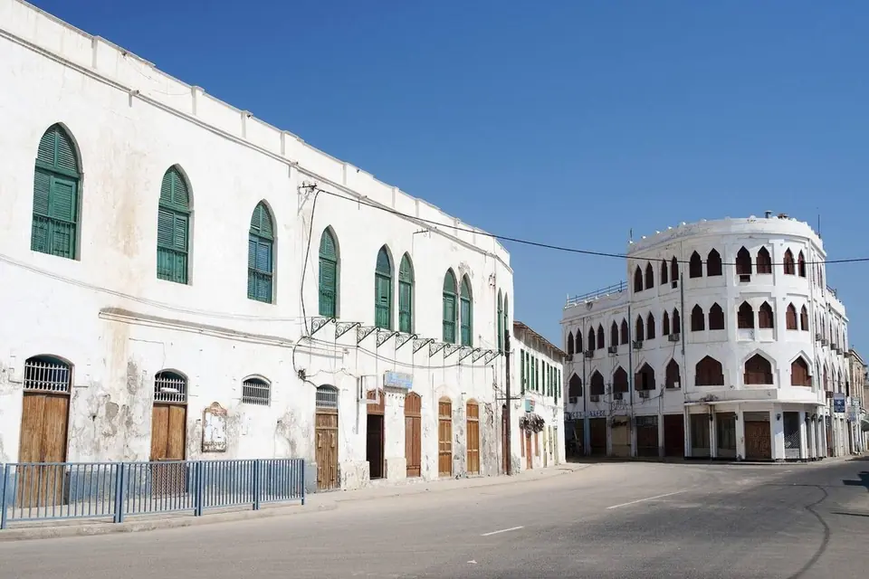 White arched buildings on a quiet street