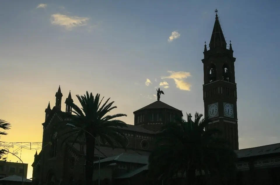 A cathedral bell tower against the sunset