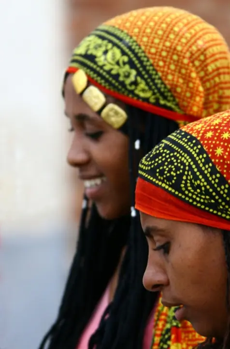 Two women in bright headwraps