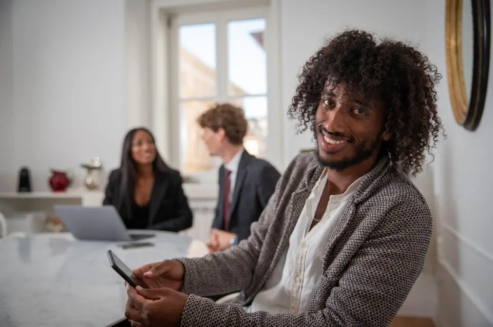 A young professional laughing in a meeting