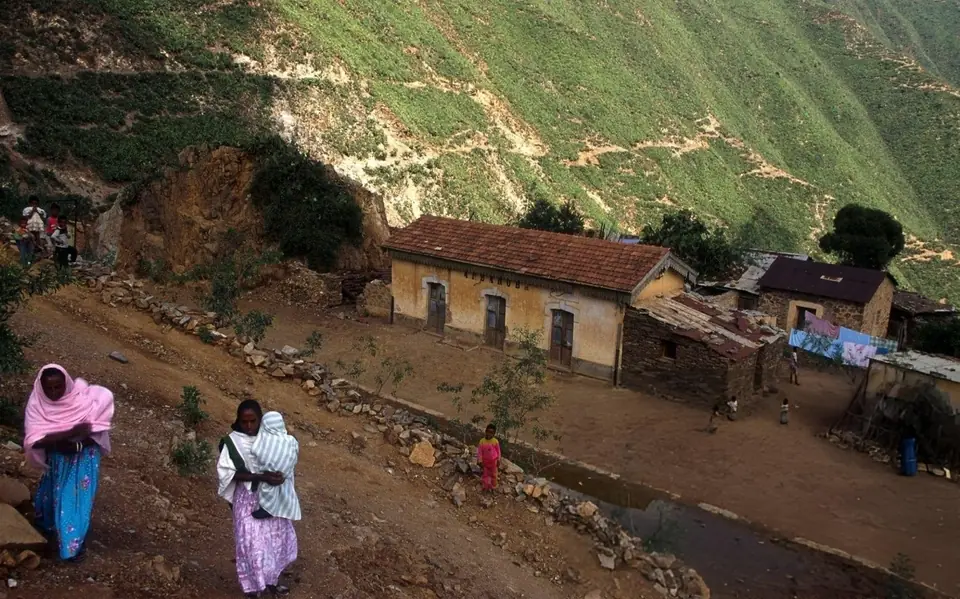 Women walking through a hillside village
